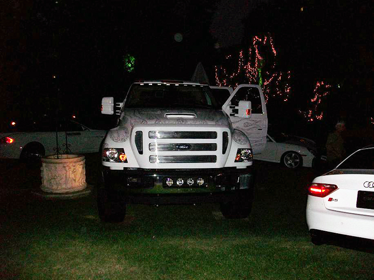 Front view of white flames Supertruck outside the Playboy mansion