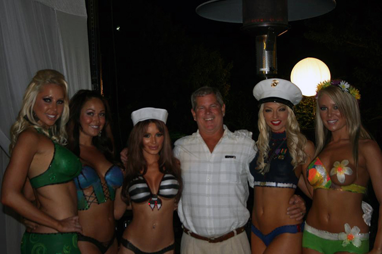 Owner Chris of Truck Customs by Chris hanging out with Playboy bunnies at 2009 Concorso Exotica event